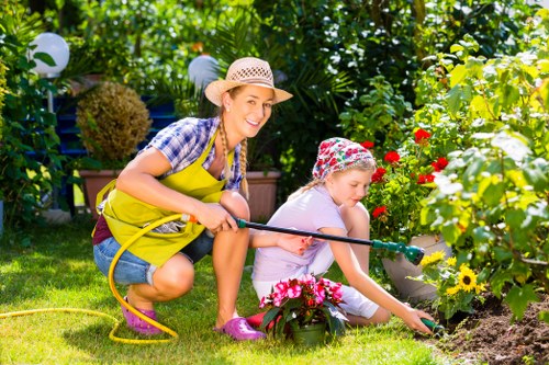 Garden care professionals clearing debris in a terraced backyard